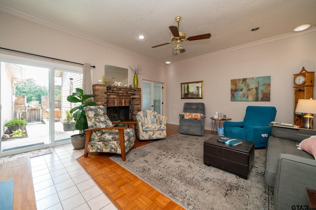 tiled living room with ceiling fan, a fireplace, crown molding, and a textured ceiling