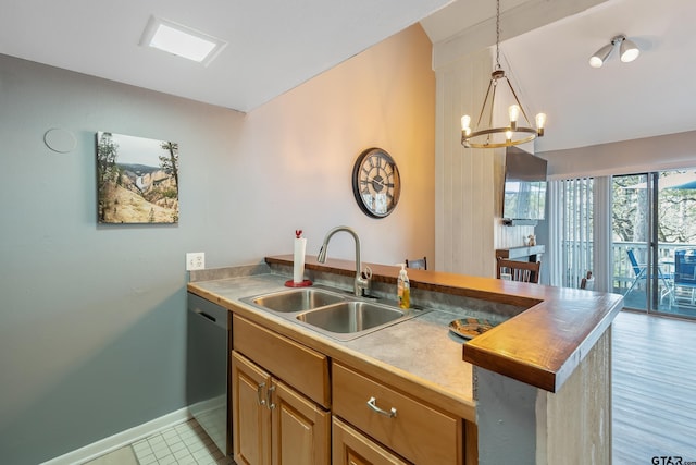 kitchen with dishwasher, butcher block countertops, sink, hanging light fixtures, and a chandelier