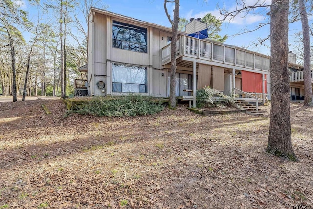 back of house featuring a sunroom