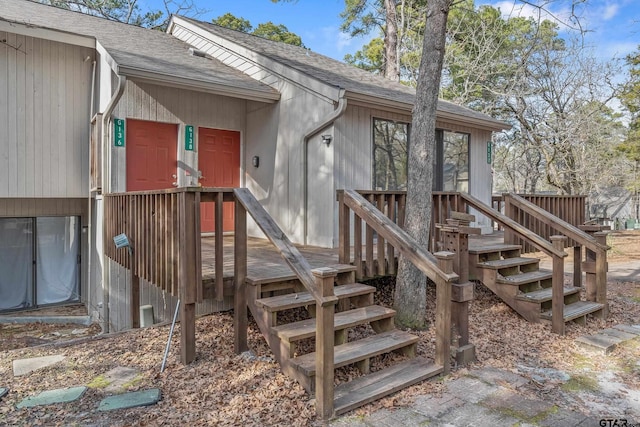 view of exterior entry with a wooden deck