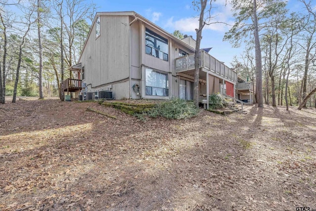 view of side of property featuring a wooden deck