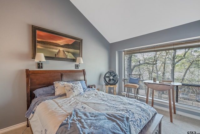 bedroom with light colored carpet and vaulted ceiling