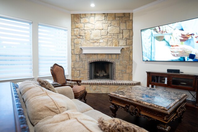 living room featuring dark hardwood / wood-style flooring, a stone fireplace, ceiling fan, and crown molding