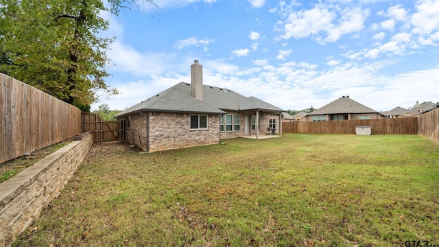 back of property featuring a lawn