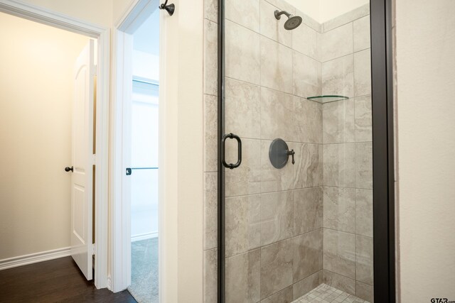 bathroom with hardwood / wood-style flooring and separate shower and tub