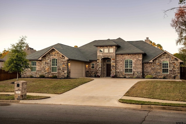 view of front of house with a lawn and a garage