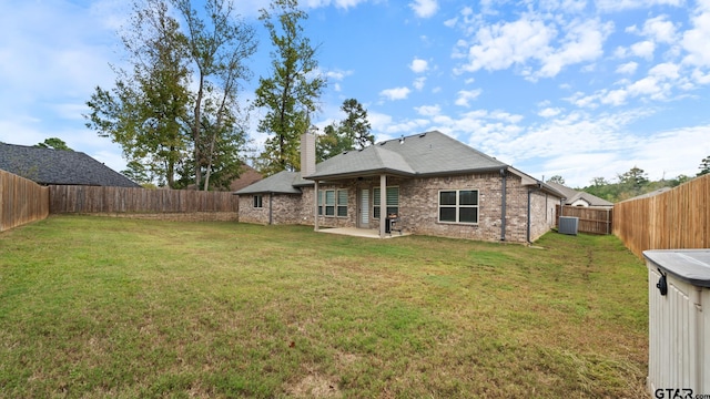 back of house featuring a patio area, a yard, and cooling unit