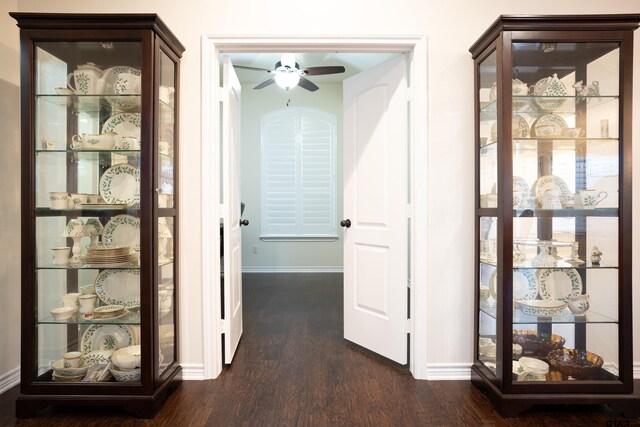 home office featuring dark hardwood / wood-style floors and ceiling fan