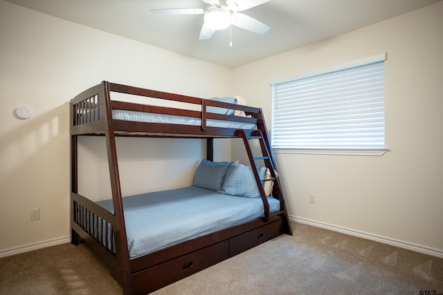 unfurnished bedroom featuring ceiling fan and dark colored carpet