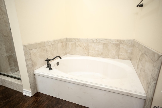 bathroom featuring a bathing tub and hardwood / wood-style flooring