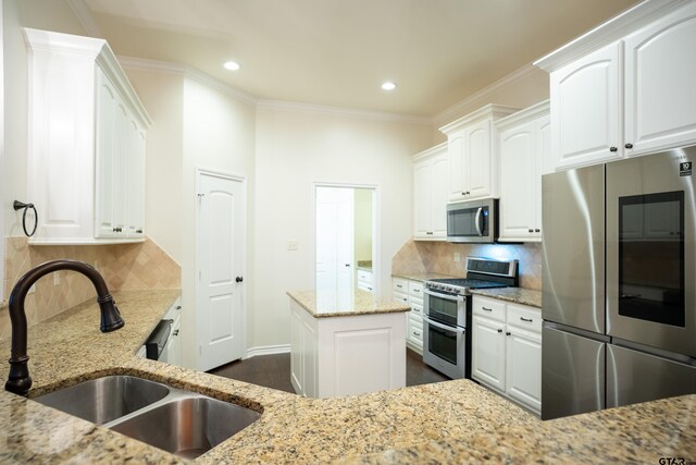 kitchen with light stone countertops, stainless steel appliances, dark hardwood / wood-style floors, decorative backsplash, and white cabinets