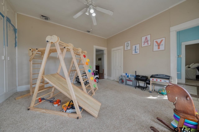 carpeted bedroom with crown molding and ceiling fan