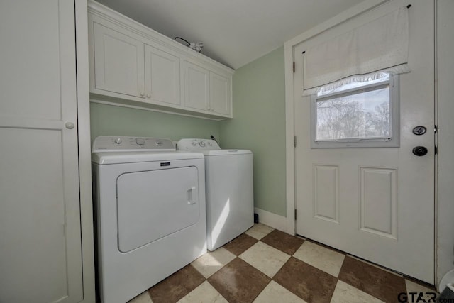 laundry area with washer and clothes dryer and cabinets