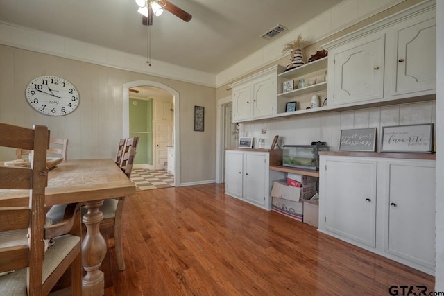 kitchen featuring white cabinets, light hardwood / wood-style floors, and ceiling fan