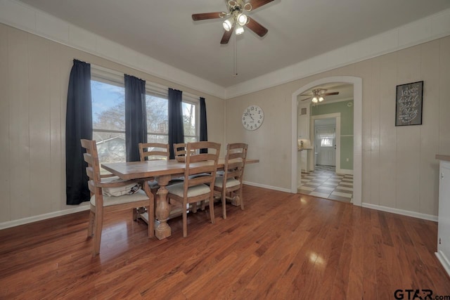 dining area with hardwood / wood-style floors and ceiling fan