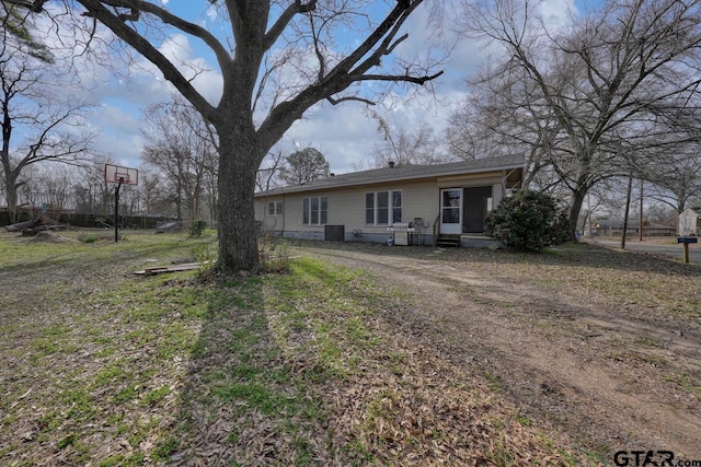 view of front of property with a front lawn and cooling unit