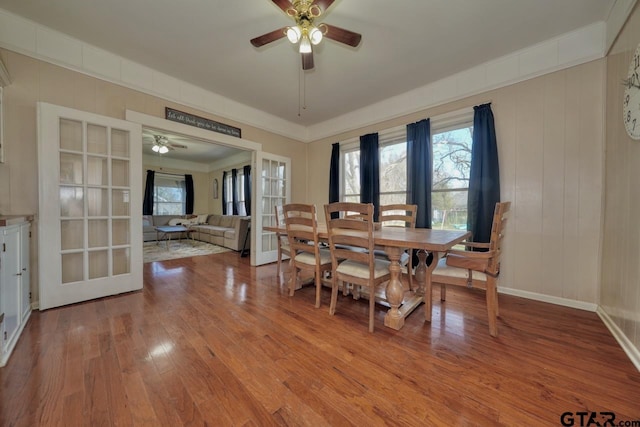 dining space with ceiling fan, plenty of natural light, light wood-type flooring, and french doors