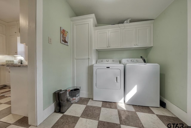 washroom featuring cabinets and washer and dryer