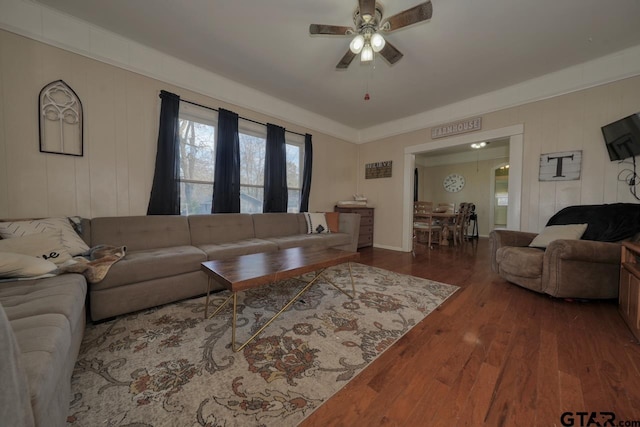 living room featuring ceiling fan and hardwood / wood-style floors