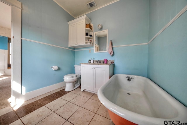 bathroom featuring vanity, a bathtub, tile patterned flooring, toilet, and ornamental molding