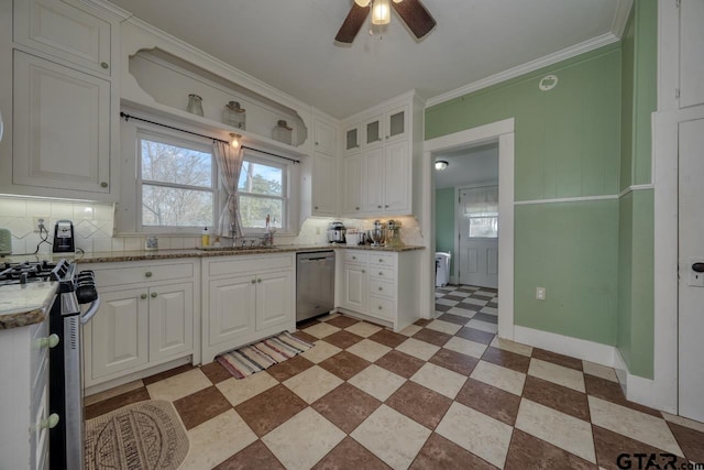 kitchen with appliances with stainless steel finishes, light stone countertops, white cabinets, backsplash, and ornamental molding