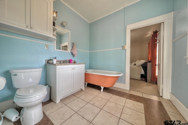 bathroom with lofted ceiling, vanity, tile patterned flooring, toilet, and a tub