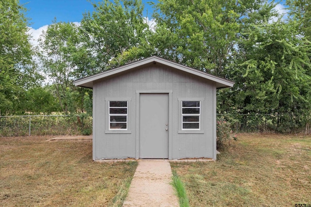 view of outbuilding featuring a lawn