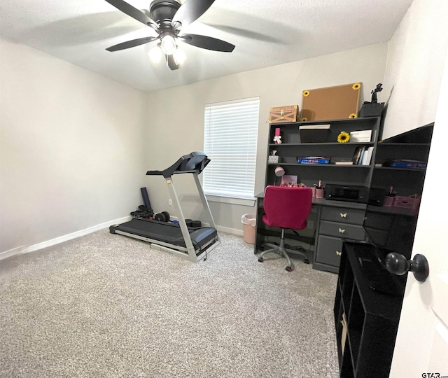 carpeted home office with a textured ceiling, a ceiling fan, and baseboards