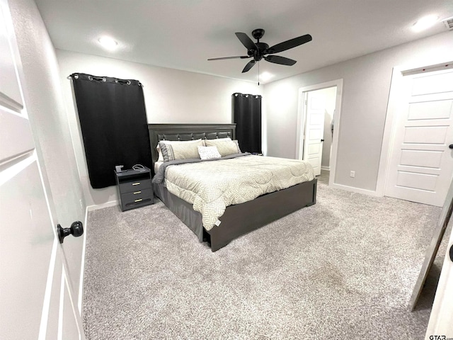 bedroom featuring baseboards, visible vents, a ceiling fan, ensuite bathroom, and carpet flooring