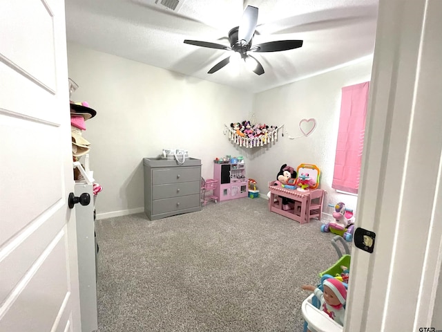 game room with carpet floors, baseboards, visible vents, and a ceiling fan