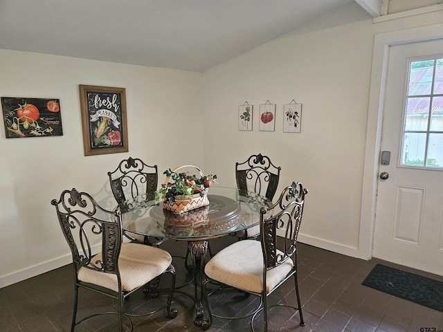301 W Larissa, Jacksonville, TX 75766 - dining room featuring baseboards, lofted ceiling, and dark tile patterned floors