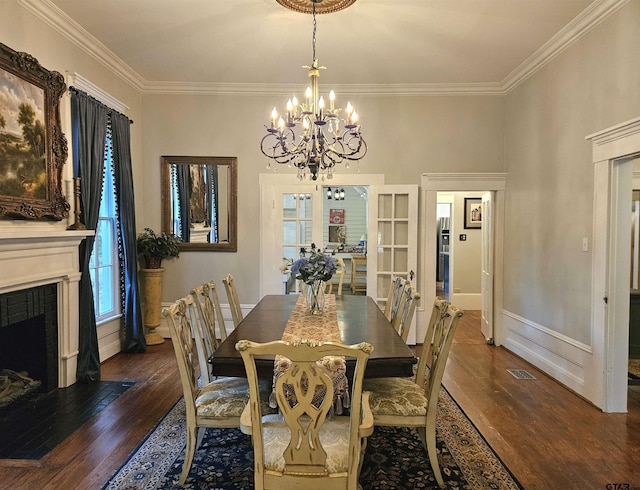 301 W Larissa, Jacksonville, TX 75766 - dining space with a chandelier, hardwood / wood-style flooring, ornamental molding, a fireplace with flush hearth, and baseboards