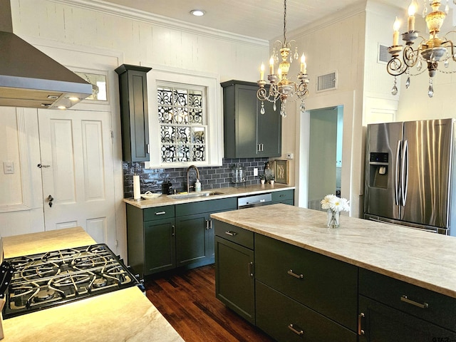 301 W Larissa, Jacksonville, TX 75766 - kitchen featuring appliances with stainless steel finishes, a chandelier, a sink, light countertops, and ornamental molding