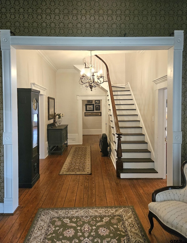 301 W Larissa, Jacksonville, TX 75766 - entrance foyer featuring wood-type flooring, a chandelier, ornamental molding, stairs, and baseboards