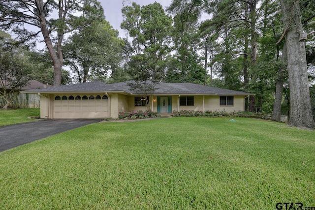 ranch-style house with a garage and a front yard