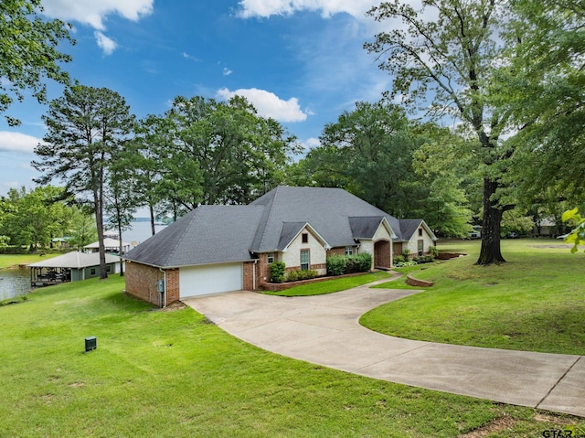 view of front of home with concrete driveway, brick siding, an attached garage, and a front lawn