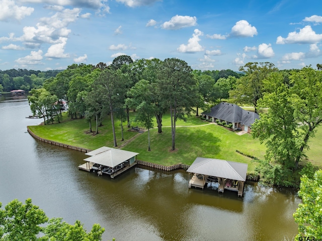 dock area with a lawn, a water view, and boat lift