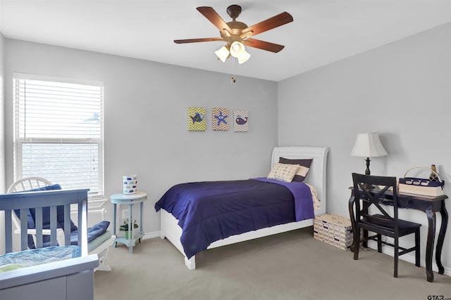 carpeted bedroom with ceiling fan and multiple windows