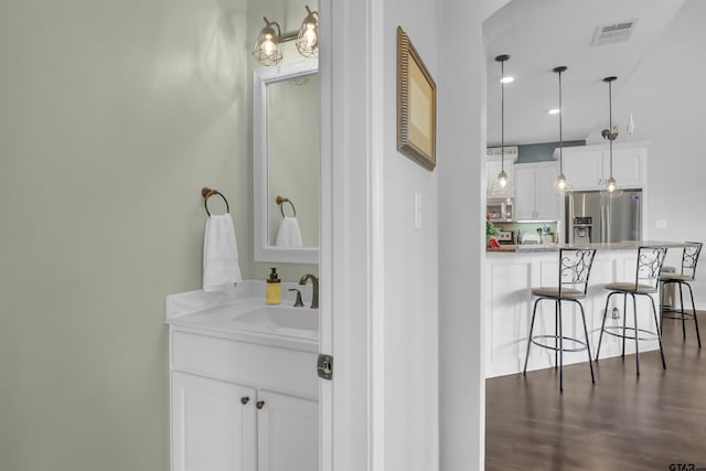 bathroom featuring hardwood / wood-style flooring and vanity