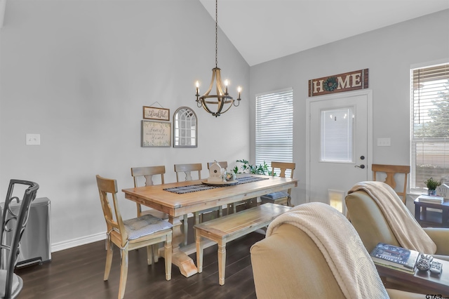 dining room with dark hardwood / wood-style flooring, lofted ceiling, and a notable chandelier