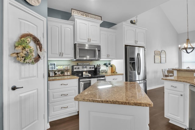 kitchen featuring pendant lighting, white cabinetry, a center island, and appliances with stainless steel finishes