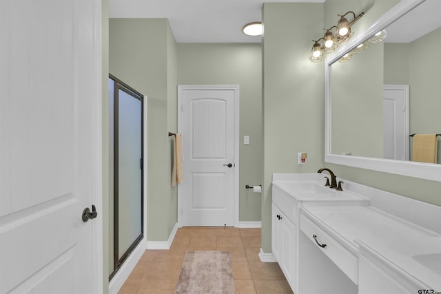 bathroom with an enclosed shower, vanity, and tile patterned flooring