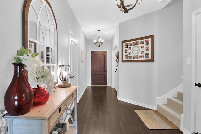 entrance foyer featuring a chandelier and dark hardwood / wood-style flooring