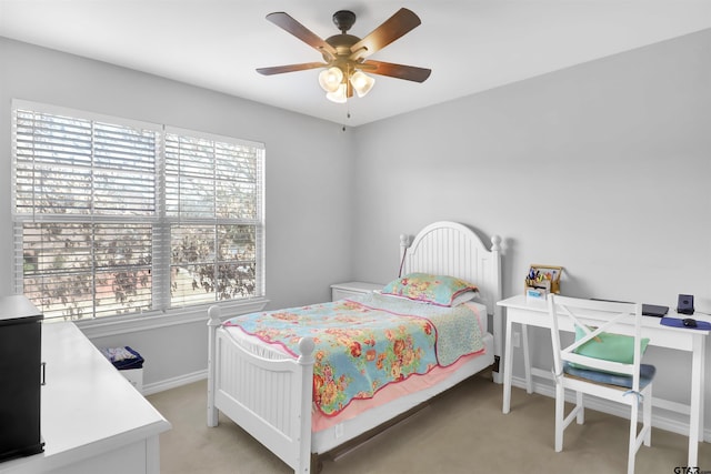 carpeted bedroom featuring ceiling fan and multiple windows