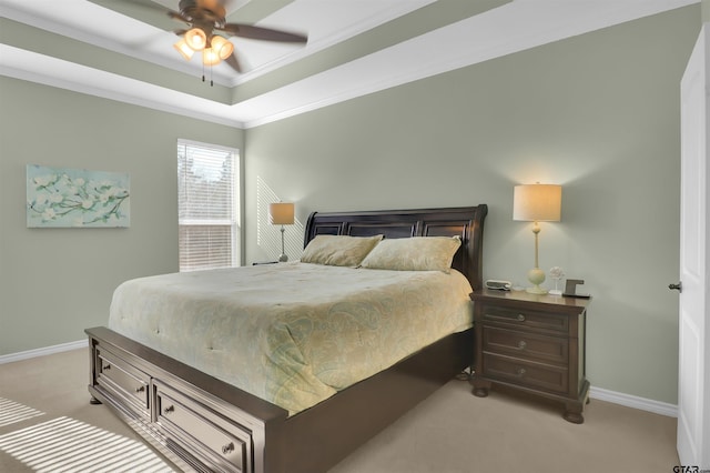 bedroom featuring ceiling fan, light colored carpet, ornamental molding, and a raised ceiling