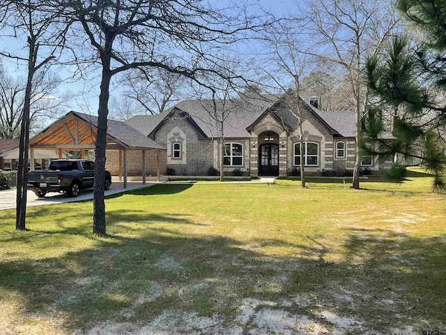 french provincial home featuring stone siding, a front lawn, and a shingled roof