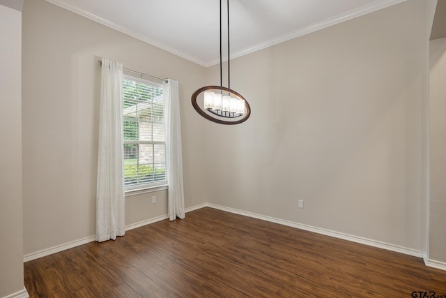 spare room with baseboards, ornamental molding, dark wood-style flooring, and a notable chandelier