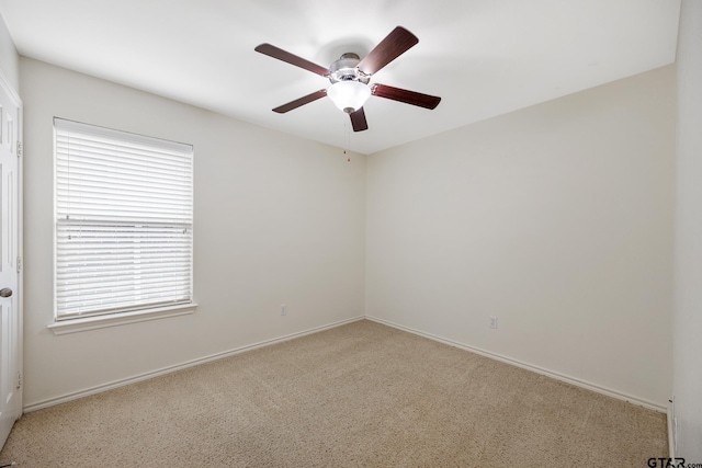 unfurnished room with plenty of natural light, carpet flooring, baseboards, and ceiling fan