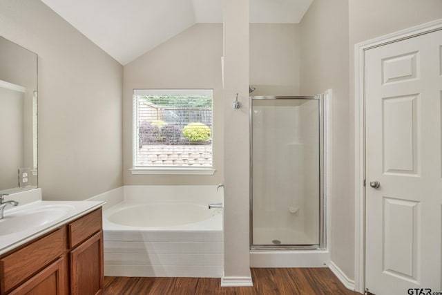 bathroom featuring a shower stall, wood finished floors, a garden tub, and vanity