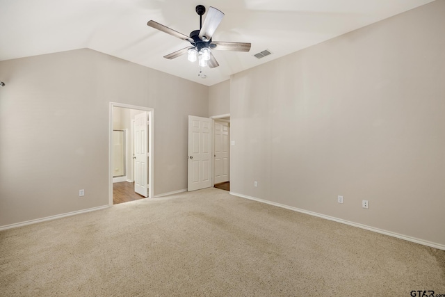 unfurnished bedroom featuring carpet flooring, connected bathroom, a ceiling fan, lofted ceiling, and visible vents